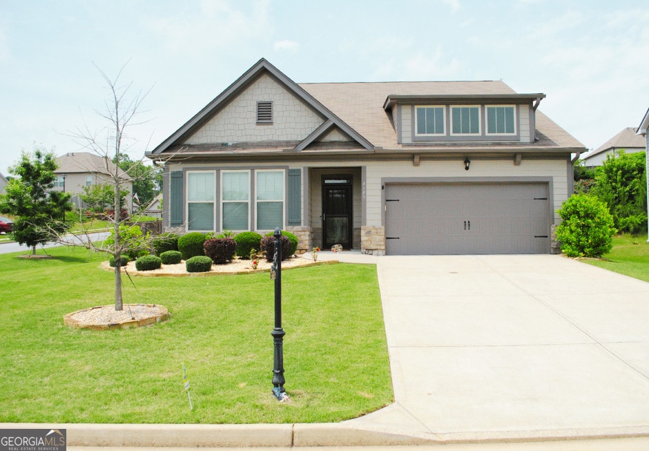 4605 Dandelion Way, Cumming, GA 30040 - craftsman house with concrete driveway, a garage, a front yard, and stone siding