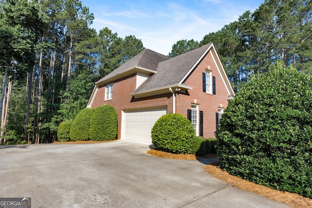 1030 Spring Lake Dr, Bishop, GA 30621 - view of side of home with driveway, brick siding, and a shingled roof
