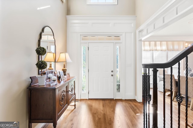 1030 Spring Lake Dr, Bishop, GA 30621 - foyer entrance featuring light wood-type flooring and a towering ceiling