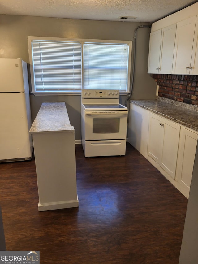 3211 Rockview Dr, Lithonia, GA 30038 - kitchen featuring white appliances, dark wood-style flooring, white cabinets, and a textured ceiling