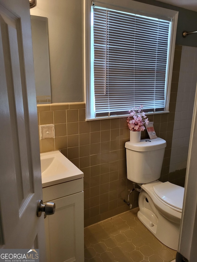 3211 Rockview Dr, Lithonia, GA 30038 - bathroom with tile walls, vanity, and tile patterned flooring