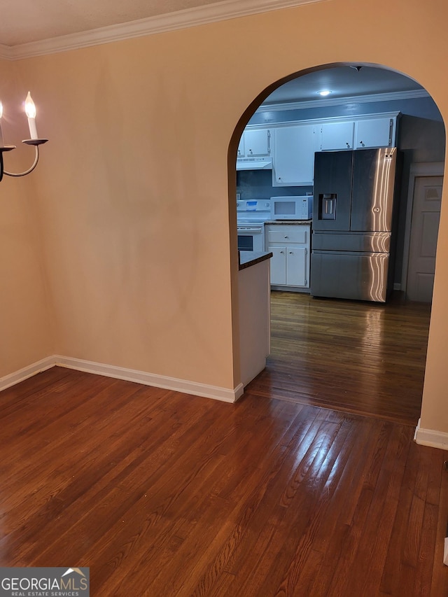 3211 Rockview Dr, Lithonia, GA 30038 - interior space with arched walkways, ornamental molding, and dark wood-style flooring