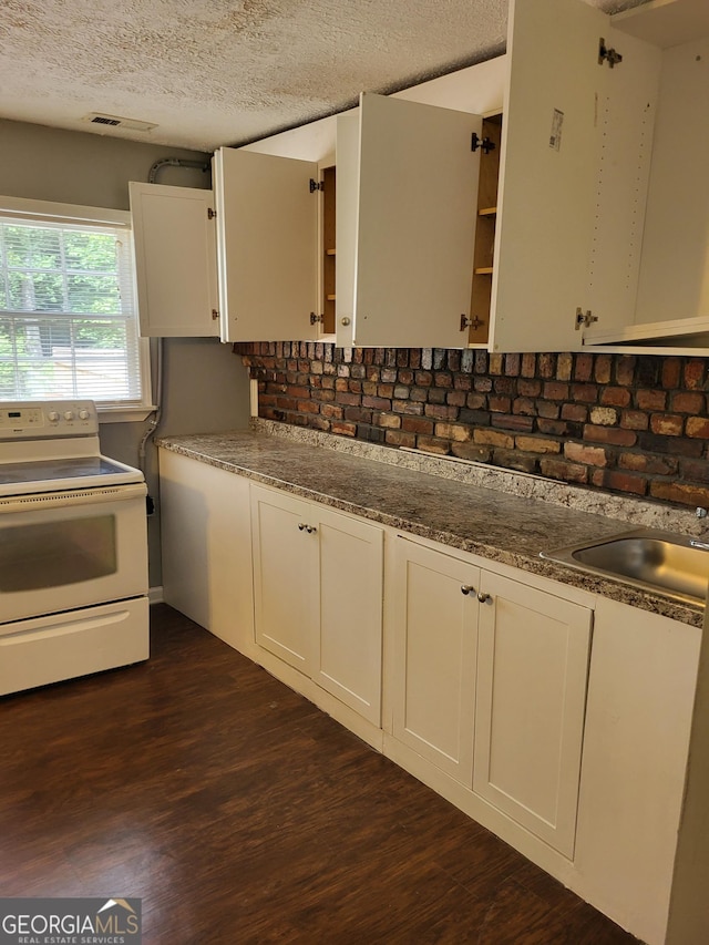 3211 Rockview Dr, Lithonia, GA 30038 - kitchen featuring white electric range, dark wood-type flooring, white cabinetry, a textured ceiling, and stone countertops