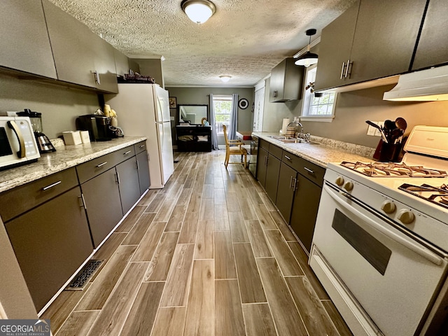 245 Clearwater Rd, Sharpsburg, GA 30277 - kitchen featuring white appliances, wood finished floors, under cabinet range hood, and a textured ceiling