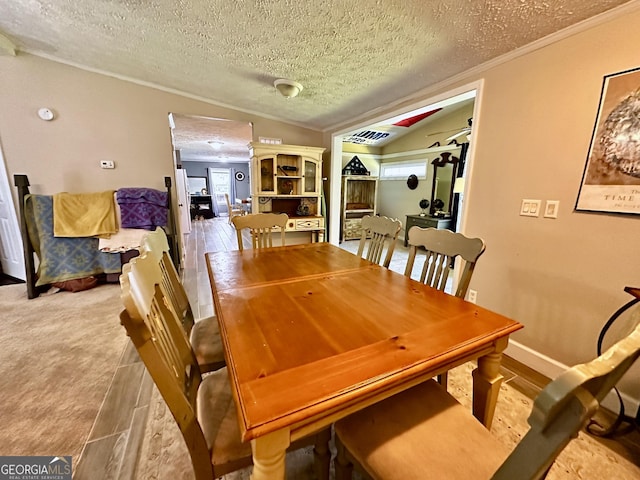 245 Clearwater Rd, Sharpsburg, GA 30277 - dining room with a textured ceiling, crown molding, lofted ceiling, and wood finished floors