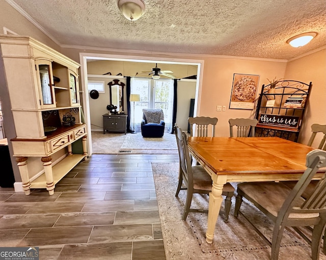 245 Clearwater Rd, Sharpsburg, GA 30277 - dining room featuring ornamental molding, ceiling fan, a textured ceiling, and wood finish floors