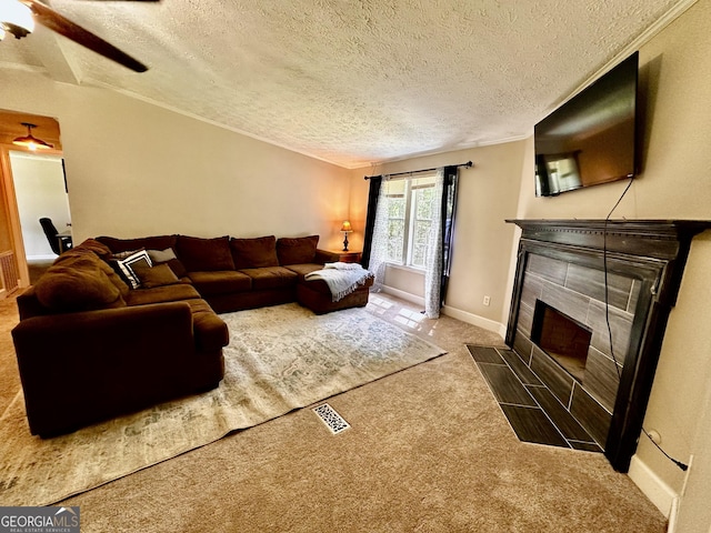 245 Clearwater Rd, Sharpsburg, GA 30277 - carpeted living area with a textured ceiling, a ceiling fan, and a tile fireplace