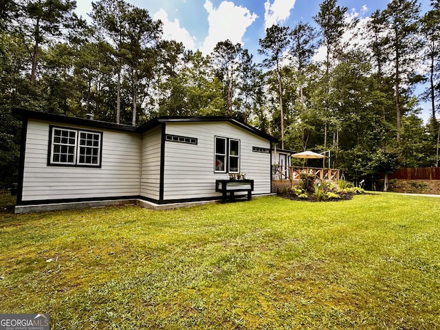 245 Clearwater Rd, Sharpsburg, GA 30277 - back of house with a deck and view of scattered trees