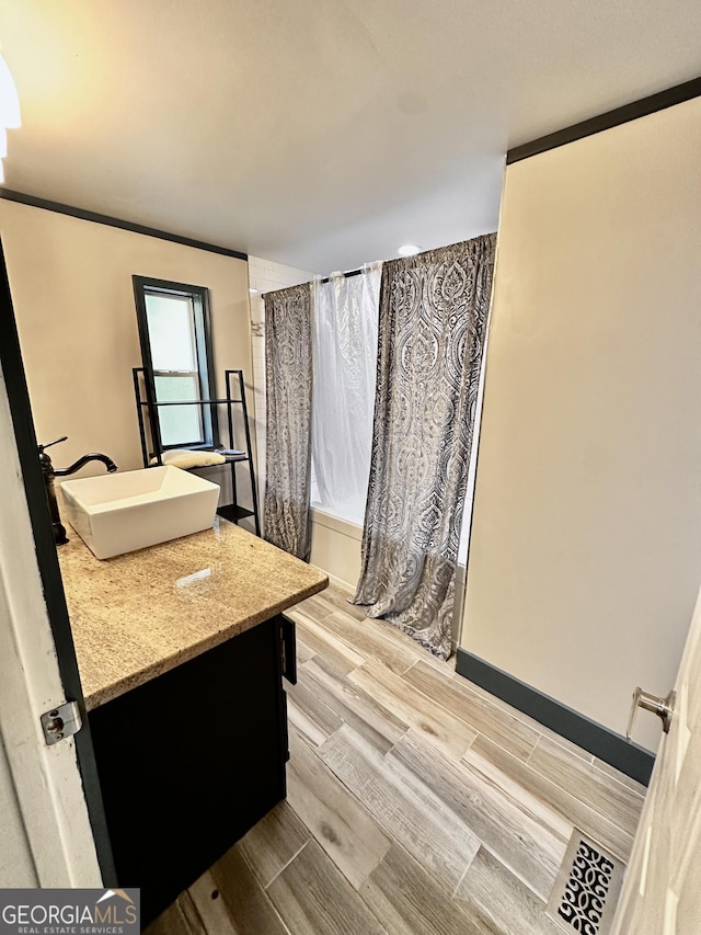 245 Clearwater Rd, Sharpsburg, GA 30277 - full bath featuring vanity, wood tiled floors, and shower / tub combo