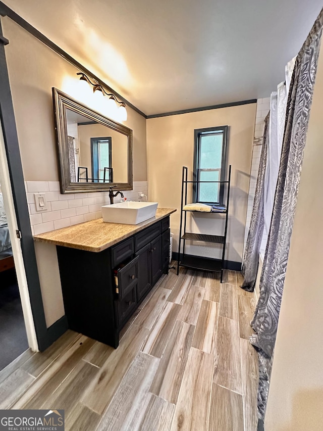 245 Clearwater Rd, Sharpsburg, GA 30277 - full bath featuring wood finished floors, vanity, backsplash, and crown molding