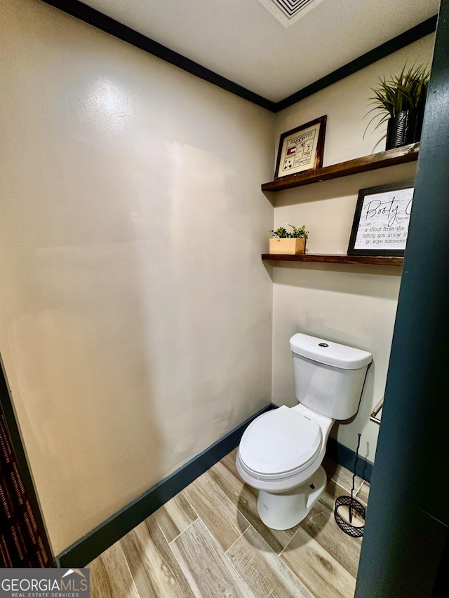 245 Clearwater Rd, Sharpsburg, GA 30277 - bathroom with wood finished floors and toilet