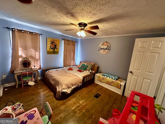 245 Clearwater Rd, Sharpsburg, GA 30277 - bedroom featuring wood finished floors, a textured ceiling, ornamental molding, and a ceiling fan