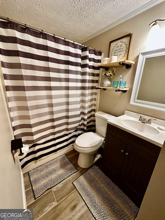 245 Clearwater Rd, Sharpsburg, GA 30277 - bathroom featuring a textured ceiling, wood finished floors, vanity, and a shower with shower curtain