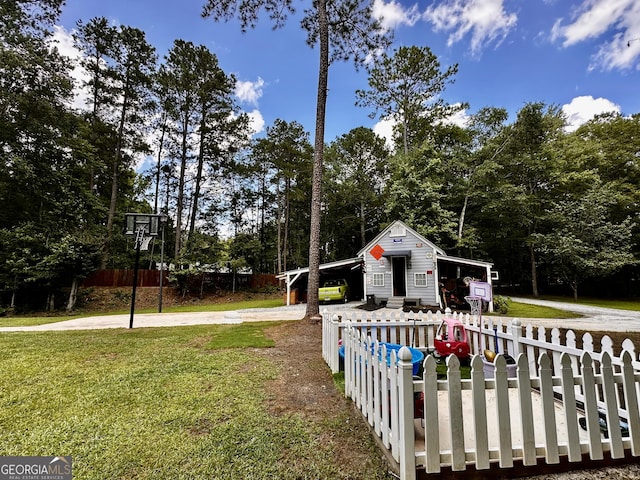 245 Clearwater Rd, Sharpsburg, GA 30277 - view of yard featuring concrete driveway, view of scattered trees, and an outbuilding