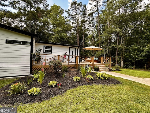 245 Clearwater Rd, Sharpsburg, GA 30277 - view of front of home with a deck and a front yard