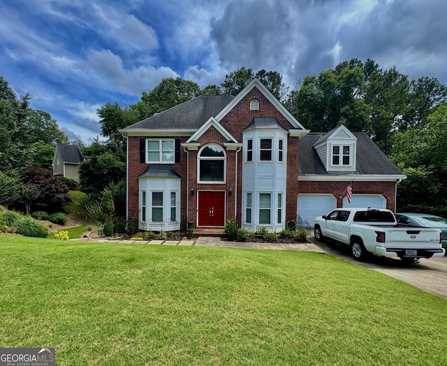 703 Overlook Pt, Woodstock, GA 30189 - view of front of home featuring brick siding, a garage, a front yard, and concrete driveway