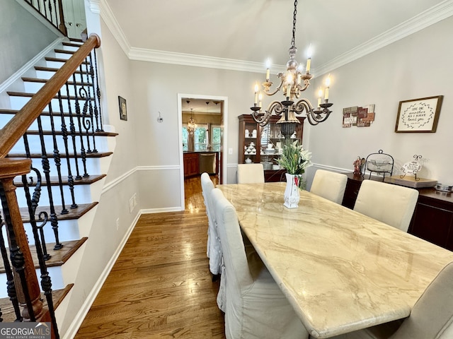 703 Overlook Pt, Woodstock, GA 30189 - dining room with a chandelier, ornamental molding, dark wood-style flooring, and stairs
