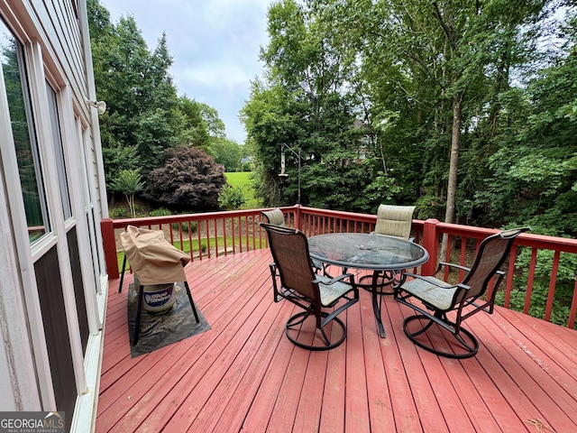 703 Overlook Pt, Woodstock, GA 30189 - wooden terrace featuring outdoor dining area and view of wooded area