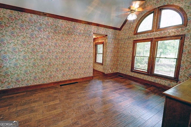 4393 Cannon Rd, Loganville, GA 30052 - spare room with wallpapered walls, lofted ceiling, ceiling fan, wood finished floors, and ornamental molding