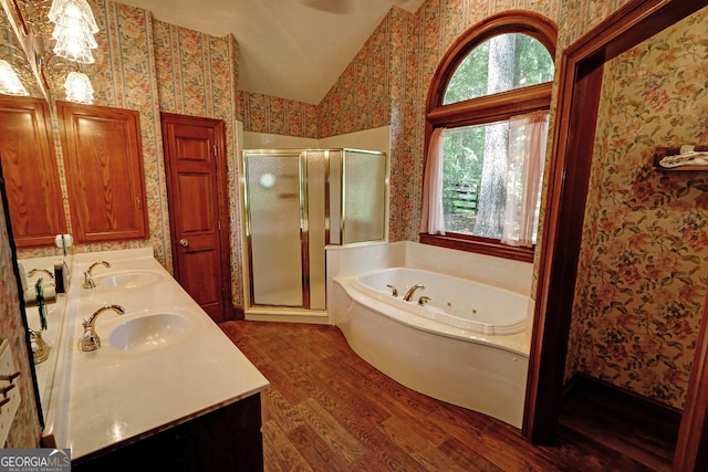 4393 Cannon Rd, Loganville, GA 30052 - full bathroom featuring lofted ceiling, wood finished floors, a stall shower, a jetted tub, and wallpapered walls