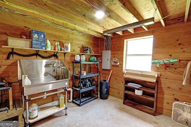 4393 Cannon Rd, Loganville, GA 30052 - misc room featuring electric panel, wood walls, and unfinished concrete floors