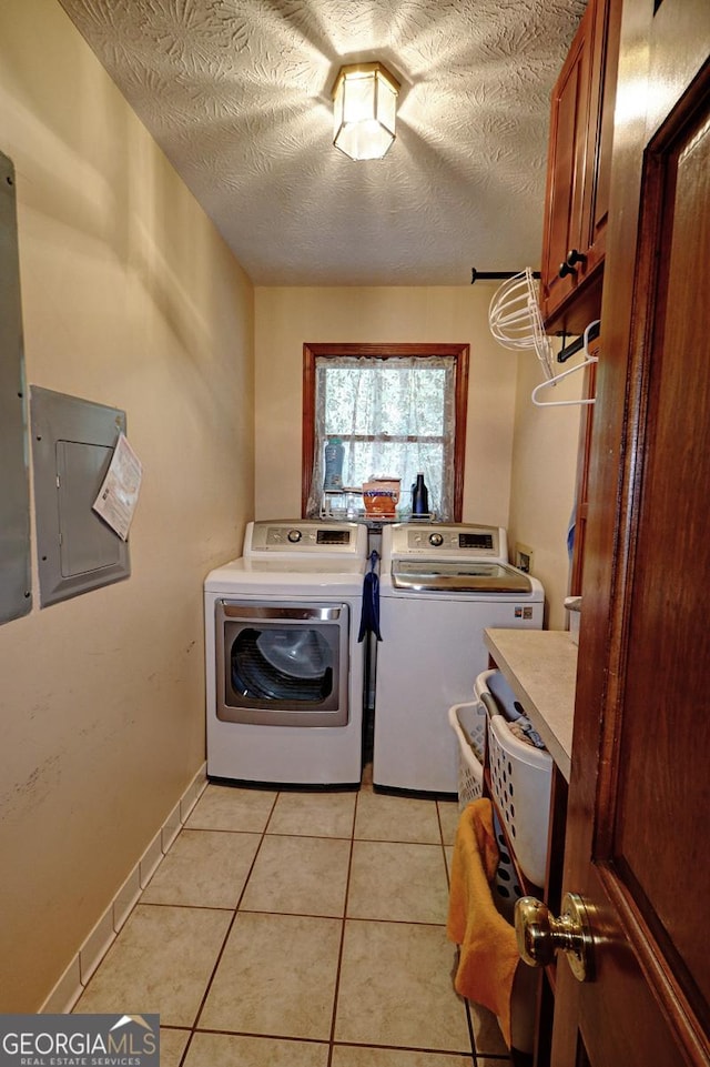 4393 Cannon Rd, Loganville, GA 30052 - laundry area with cabinet space, washing machine and dryer, electric panel, light tile patterned floors, and a textured ceiling