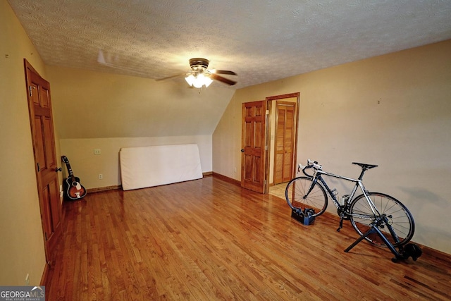 4393 Cannon Rd, Loganville, GA 30052 - additional living space featuring ceiling fan, wood finished floors, a textured ceiling, and vaulted ceiling