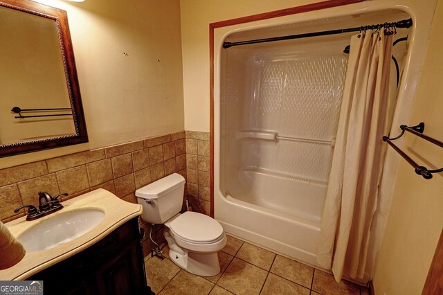 4393 Cannon Rd, Loganville, GA 30052 - full bathroom with tile walls, vanity, wainscoting, shower / bathtub combination with curtain, and tile patterned floors