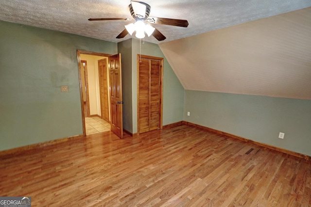 4393 Cannon Rd, Loganville, GA 30052 - bonus room with light wood-style flooring, a ceiling fan, a textured ceiling, and vaulted ceiling