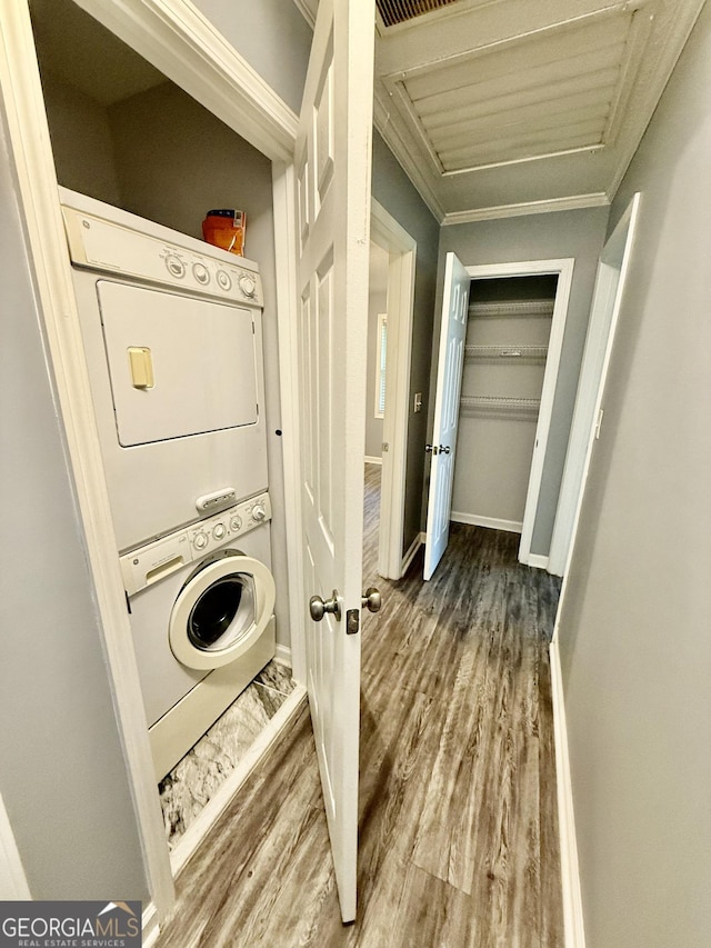 873 US Highway 280, Claxton, GA 30417 - laundry area with stacked washer and clothes dryer, wood finished floors, and ornamental molding