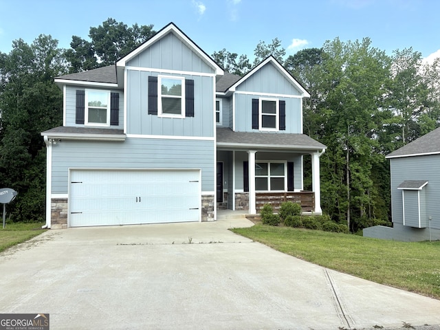 248 Webster Lake Dr, Temple, GA 30179 - view of front of property featuring a porch, stone siding, concrete driveway, an attached garage, and a front lawn