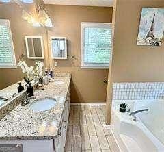 507 Legacy Park Ln, Powder Springs, GA 30127 - bathroom featuring double vanity, a bath, and a ceiling fan