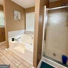 507 Legacy Park Ln, Powder Springs, GA 30127 - full bathroom featuring a garden tub, a shower with shower door, and tile patterned floors