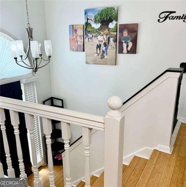 507 Legacy Park Ln, Powder Springs, GA 30127 - stairway with a chandelier and wood finished floors