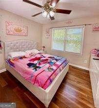 507 Legacy Park Ln, Powder Springs, GA 30127 - bedroom featuring dark wood finished floors and ceiling fan