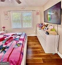 507 Legacy Park Ln, Powder Springs, GA 30127 - bedroom with wood finished floors and a ceiling fan