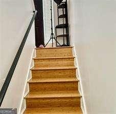 507 Legacy Park Ln, Powder Springs, GA 30127 - staircase featuring baseboards and wood finished floors
