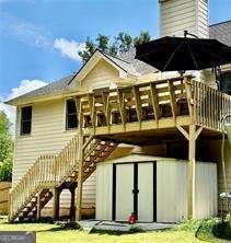 507 Legacy Park Ln, Powder Springs, GA 30127 - back of property with stairs, a storage shed, and a deck