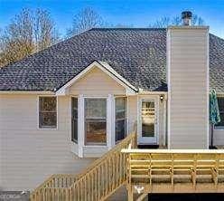507 Legacy Park Ln, Powder Springs, GA 30127 - rear view of property featuring a deck and a chimney
