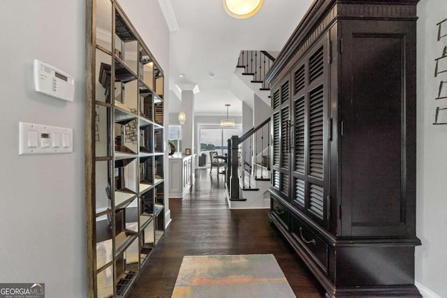 202 Jackson Rd SE, Milledgeville, GA 31061 - entrance foyer with crown molding, stairs, and dark wood finished floors