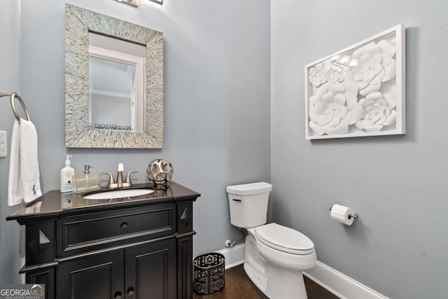 202 Jackson Rd SE, Milledgeville, GA 31061 - half bath featuring vanity and wood finished floors
