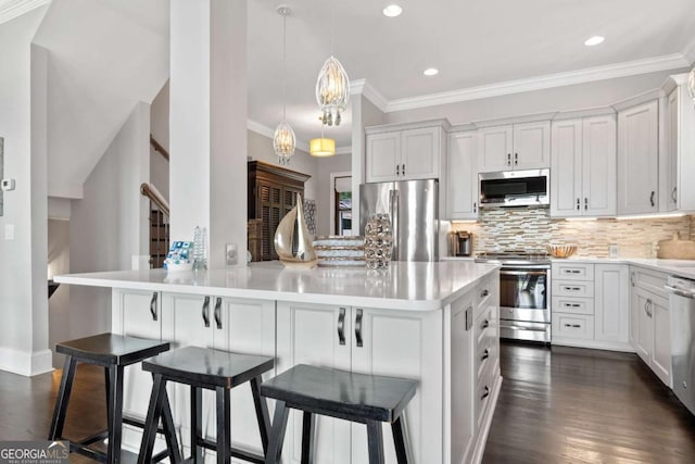 202 Jackson Rd SE, Milledgeville, GA 31061 - kitchen with stainless steel appliances, ornamental molding, decorative backsplash, recessed lighting, and light countertops