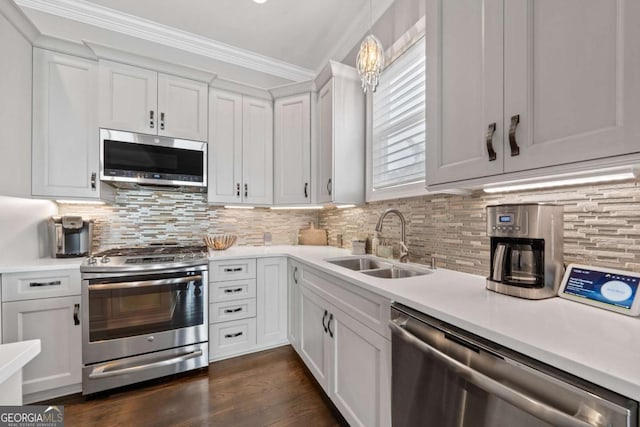 202 Jackson Rd SE, Milledgeville, GA 31061 - kitchen with stainless steel appliances, light countertops, white cabinets, and ornamental molding