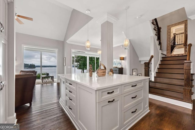 202 Jackson Rd SE, Milledgeville, GA 31061 - kitchen featuring dark wood-type flooring, white cabinetry, vaulted ceiling, decorative light fixtures, and light countertops