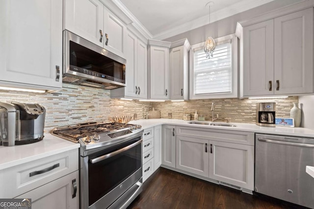202 Jackson Rd SE, Milledgeville, GA 31061 - kitchen featuring stainless steel appliances, light countertops, backsplash, white cabinets, and ornamental molding