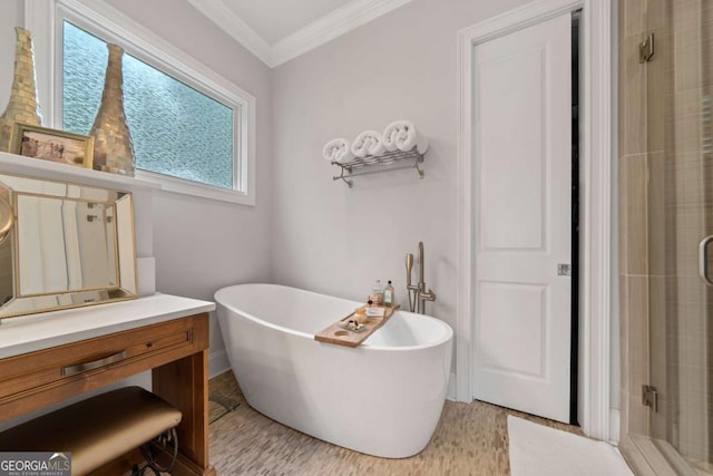 202 Jackson Rd SE, Milledgeville, GA 31061 - bathroom featuring a stall shower, a freestanding bath, ornamental molding, and vanity