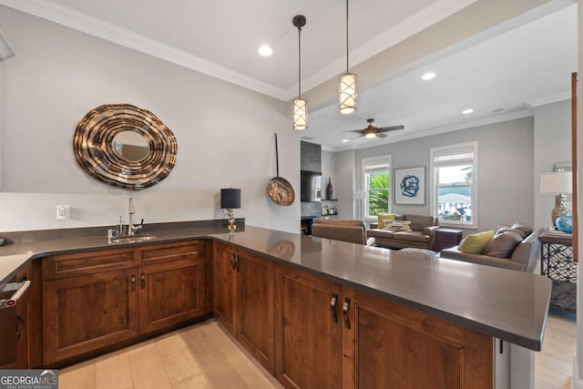 202 Jackson Rd SE, Milledgeville, GA 31061 - kitchen with dark countertops, recessed lighting, crown molding, a peninsula, and pendant lighting