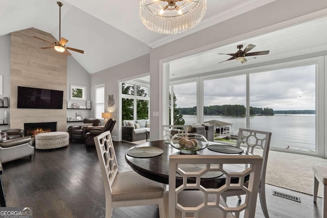 202 Jackson Rd SE, Milledgeville, GA 31061 - dining room with ceiling fan, high vaulted ceiling, a fireplace, a water view, and wood finished floors
