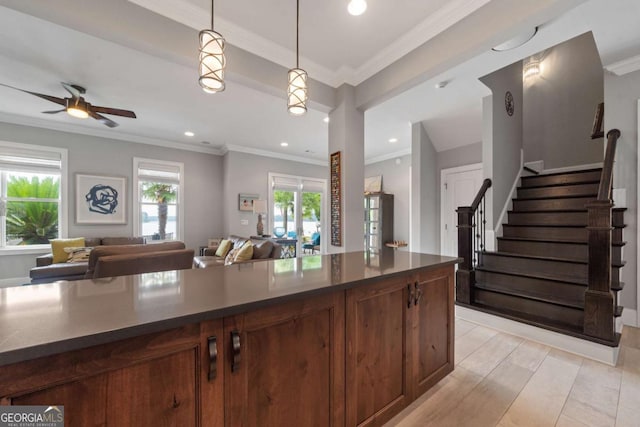 202 Jackson Rd SE, Milledgeville, GA 31061 - kitchen with dark countertops, decorative light fixtures, open floor plan, ornamental molding, and a ceiling fan