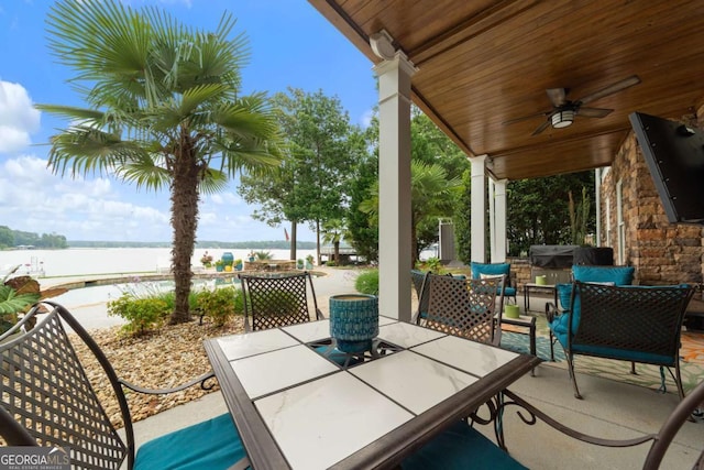 202 Jackson Rd SE, Milledgeville, GA 31061 - view of patio with a water view, outdoor dining space, and a ceiling fan